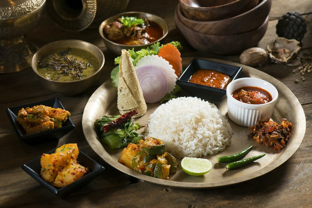 Traditional Bangladeshi meal of rice with vegetables, dal and curries on a plate