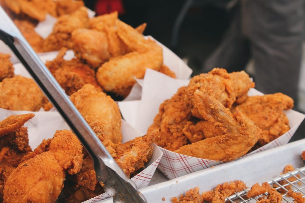 Golden crispy fried chicken pieces on brown paper