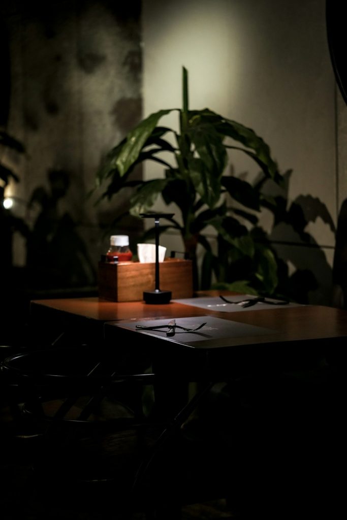 Quiet dining table with a warm lamp in a softly lit restaurant