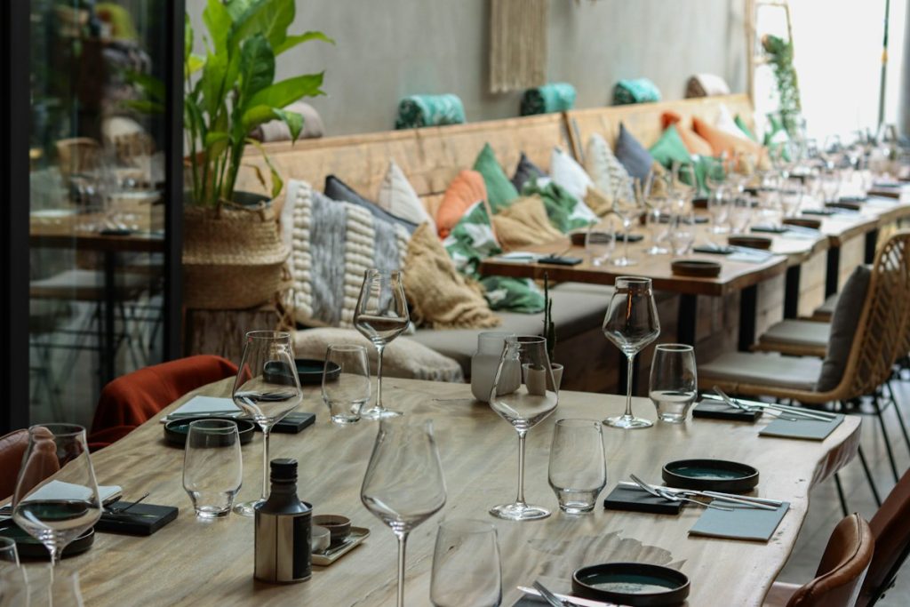 Long private dining table set with glasses and place settings